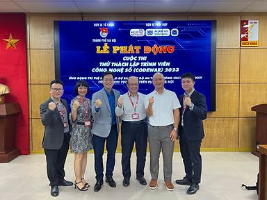 Partners and officials posing at the opening ceremony stage in Hanoi