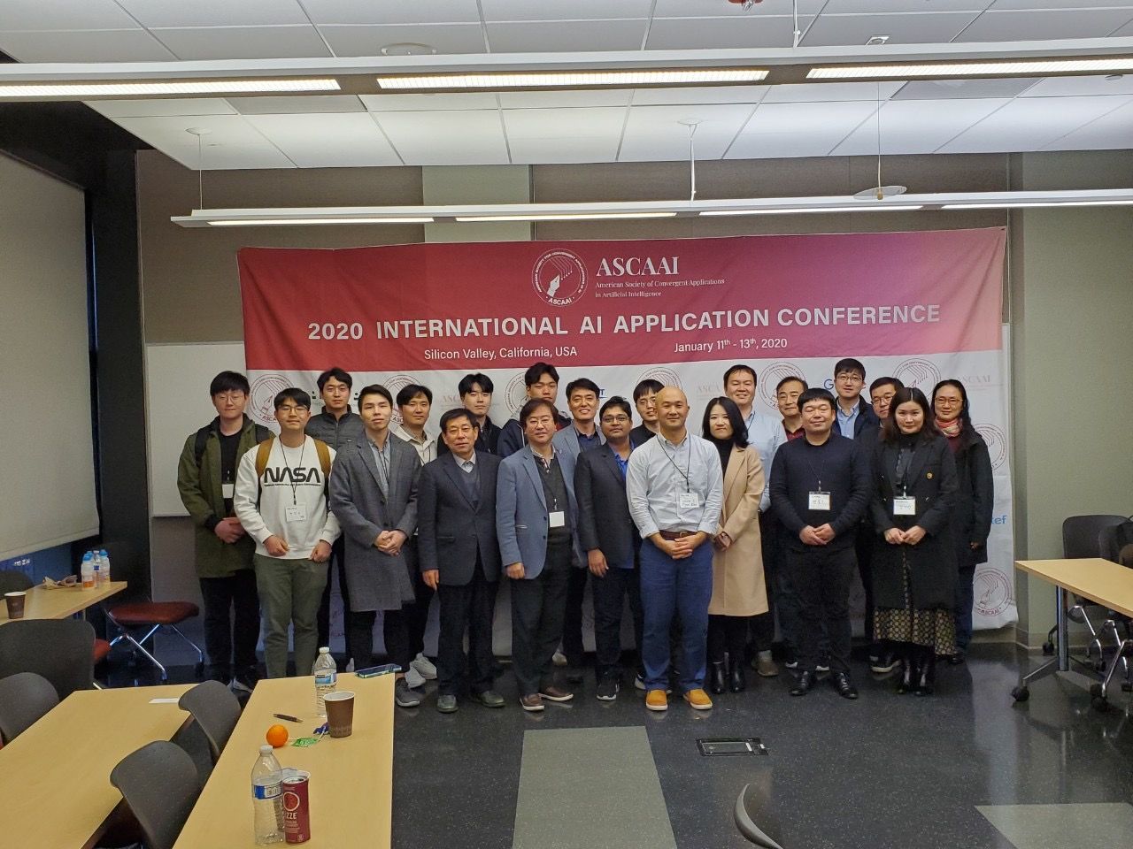 Group photo of conference participants in front of a 2020 International AI Application Conference banner