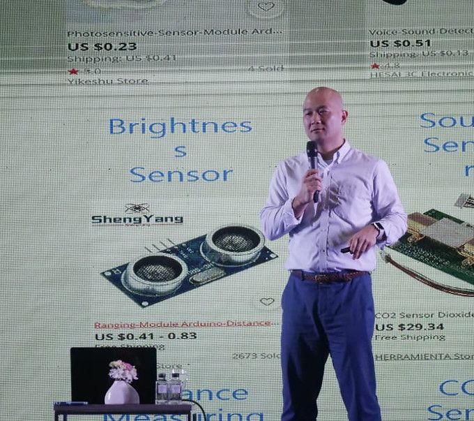 Speaker presenting in front of a slide about sensors